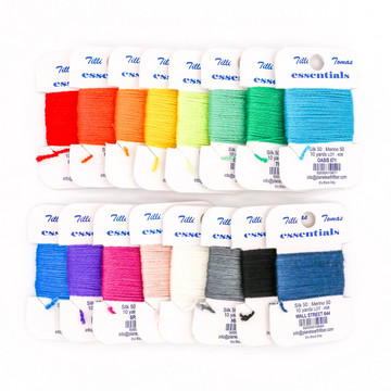Needlepoint thread color cards showing wool and silk fibers in bright shades, arranged for easy comparison and selection
