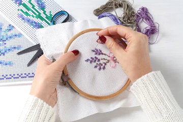 Needlepoint stitching in embroidery hoop highlighting consistent tension and careful technique before finishing work