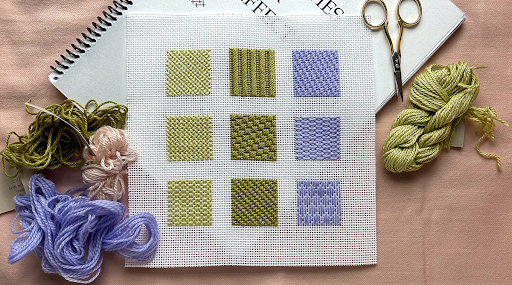 Needlepoint sampler with stitched sections, colorful threads, and scissors showcasing various needlepoint stitches for beginners