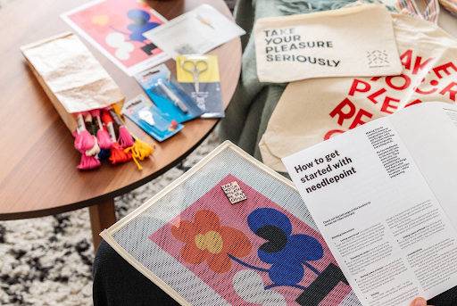 Needlepoint accessories with threads, scissors, and a canvas, perfect setup for learning how to needlepoint efficiently