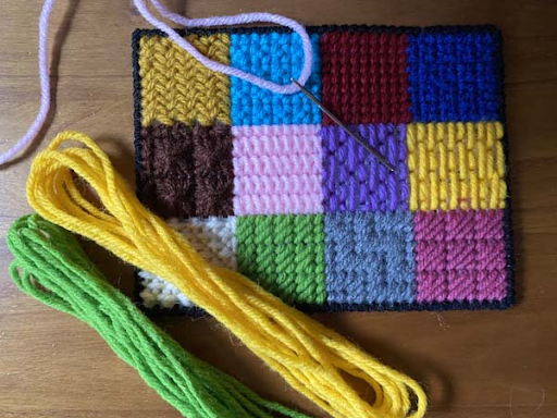 Different needlepoint background stitches shown on canvas with thread and needle, illustrating beginner needlepoint stitches