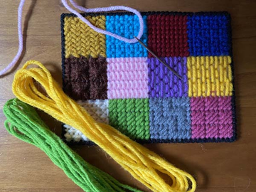 Different needlepoint background stitches shown on canvas with thread and needle, illustrating beginner needlepoint stitches