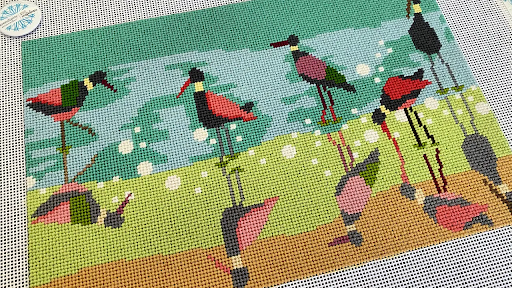 Colorful needlepoint design featuring birds, stitched with needlepoint for rich texture and detail.