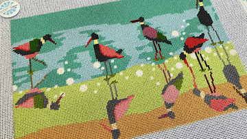 Colorful needlepoint design featuring birds, stitched with needlepoint for rich texture and detail.